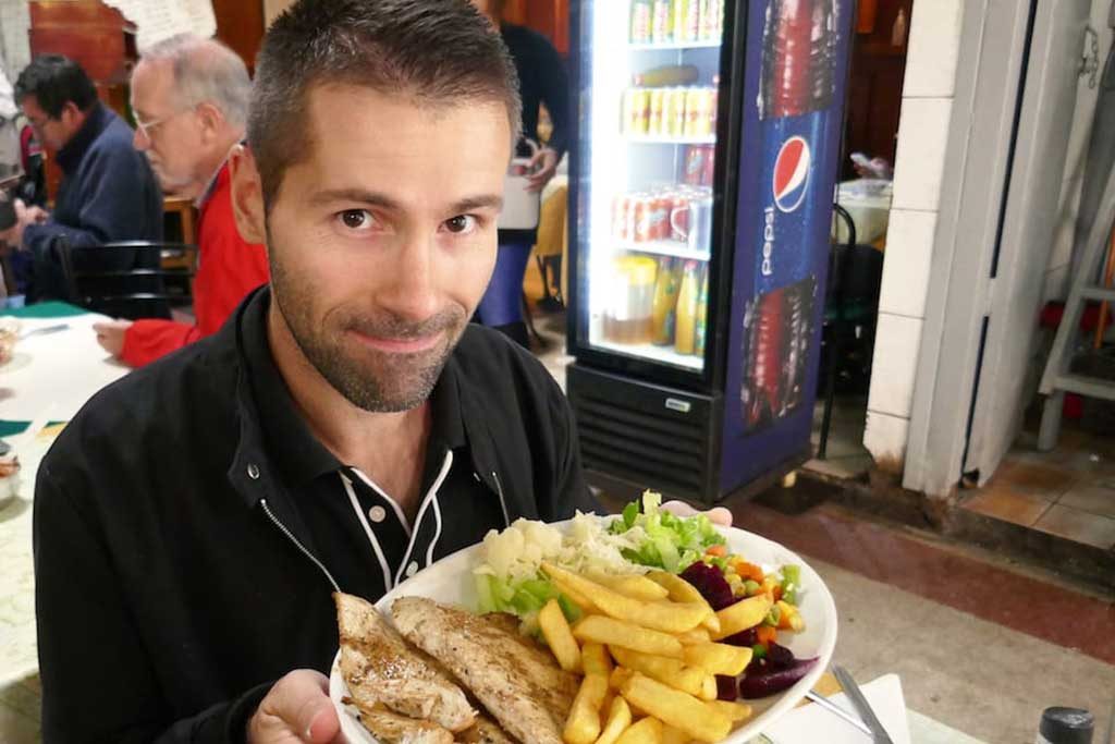 Seby tucking into a plate of fresh fish and chips at Santiago’s Mercado Central