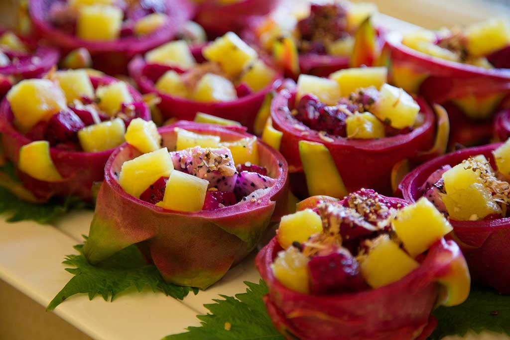 Kaleidoscopic brunch salad served in dragon fruit hulls
